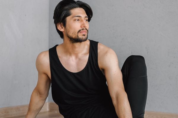 Man sitting in a relaxed posture after strength workout session